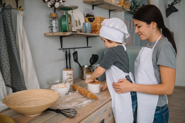 mom and boy preparing dough for Christmas cookies