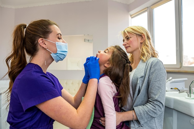 Mom and child visit their pediatric dentist Doctor talking with patient Healthcare