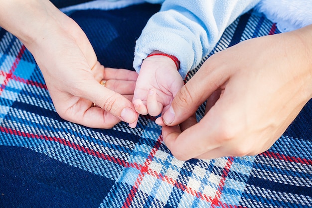 Mom and Dad hold the hand of his young child