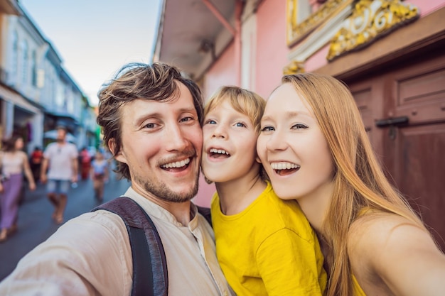 Mom Dad and Son tourists on the Street in the Portugese style Romani in Phuket Town Also called Chinatown or the old town Traveling with kids concept