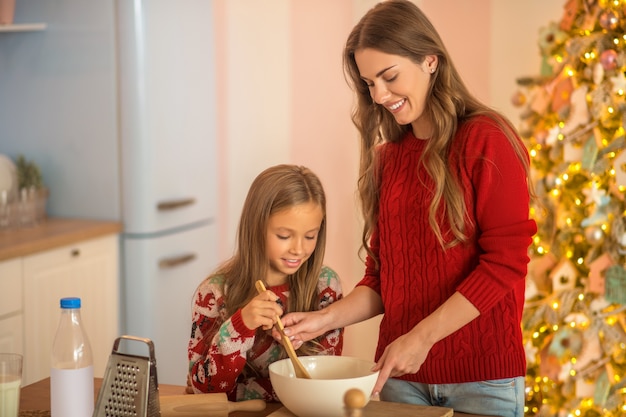 Mom and daughter cooking together in the kitchen