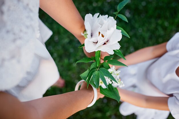 Mom and daughter holding hands in blossom spring garden