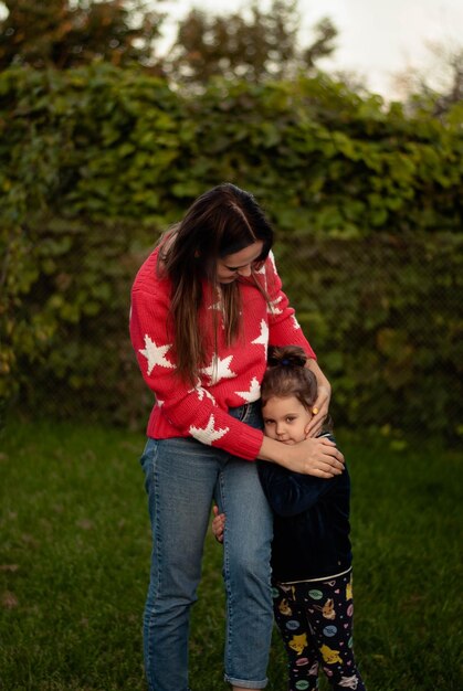 mom and daughter hug a warm evening the love of mother and daughter green grass nature