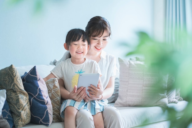 Mom and daughter operating a tablet device