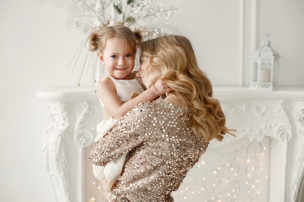 Mom and daughter playing together in white sudio