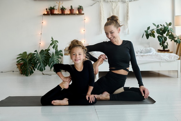 Mom and daughter smiling during workout