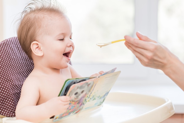 Mom feeds the kid porridge at home