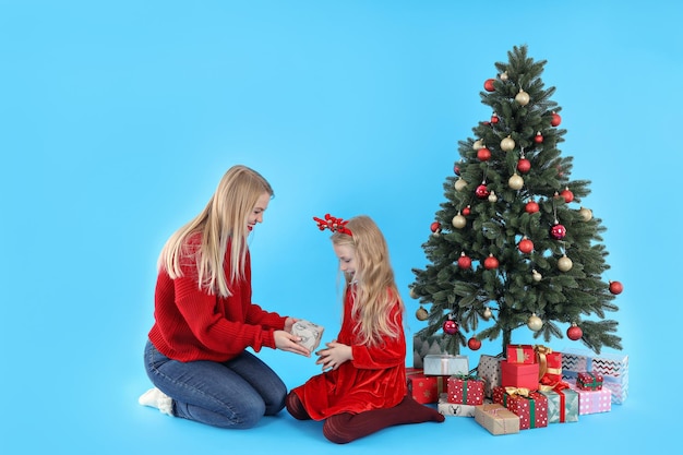 Mom gives a gift to her daughter on blue background