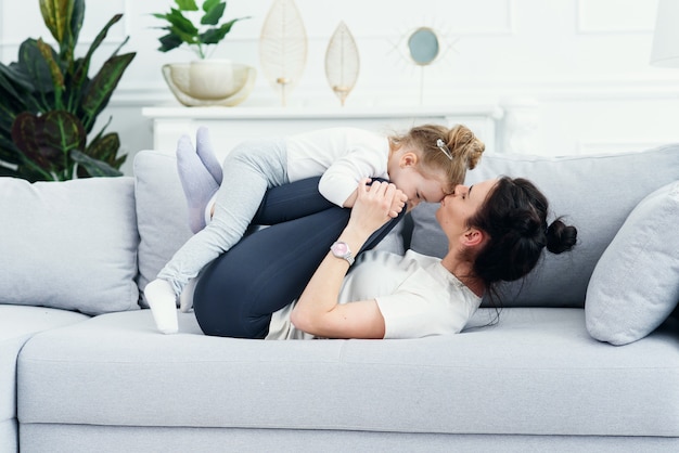 Mom and her daughter laying on the couch in the living room