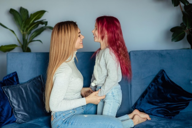 Mom and her daughter play at home Family vacation and togetherness