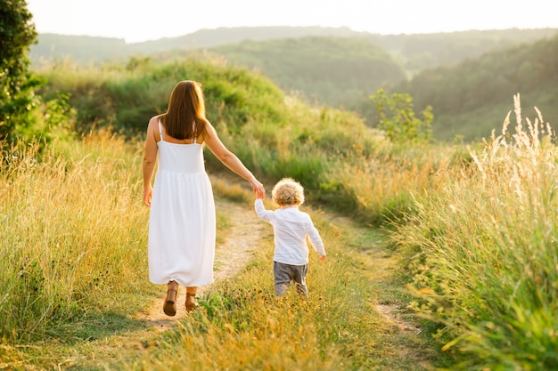 Mom and her son are walking