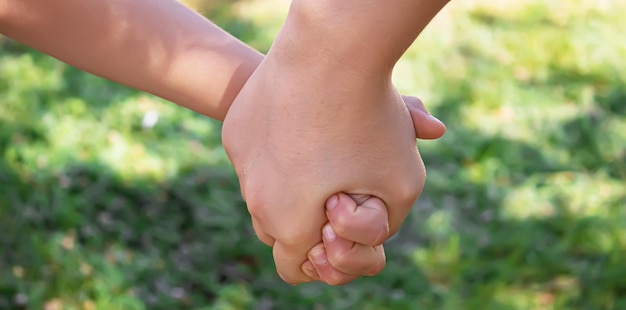 Mom holding baby by the hand selective focuspeople