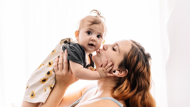 Mom kissing baby on cheek