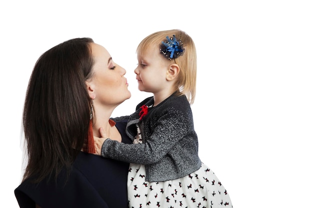 Mom and little daughter hug and kiss Love and tenderness Isolated on white background Space for text