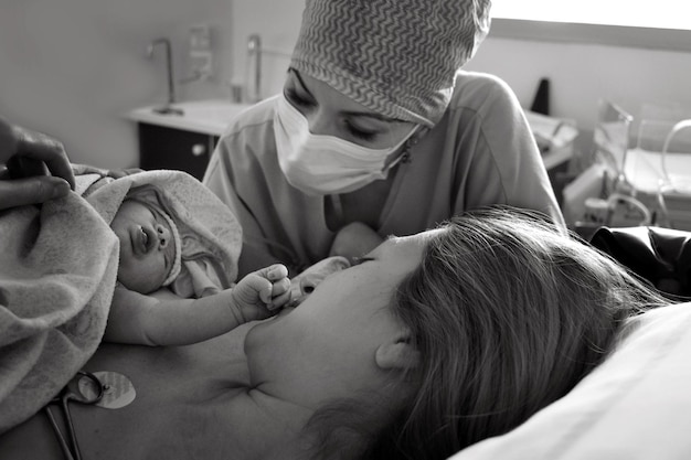 Mom and newborn baby skin to the skin after birth in the hospital