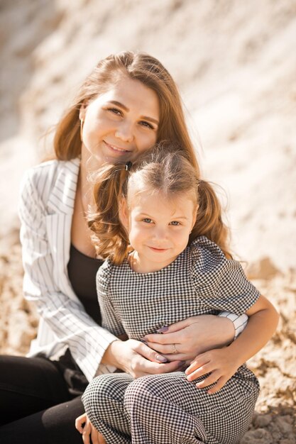 Mom plays with her daughter in nature among the sands 3364