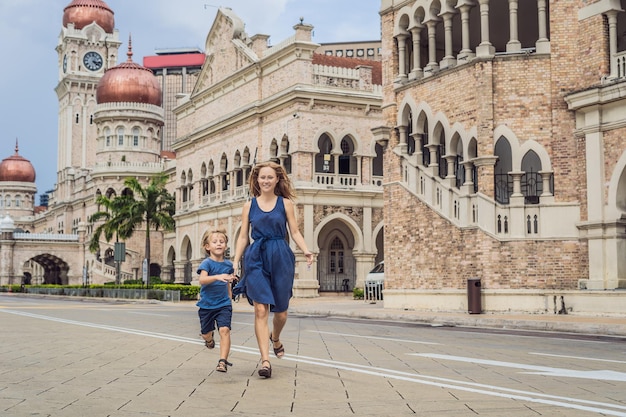 Mom and son on background of Sultan Abdul Samad Building in Kuala Lumpur, Malaysia. Traveling with children concept