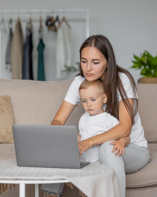 Mom and son at home in the living room parenting and business for a young european mom a woman is