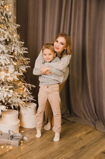 Mom and son near the Christmas tree at home