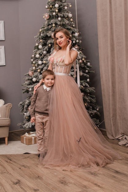 Mom and son near the Christmas tree New year concept