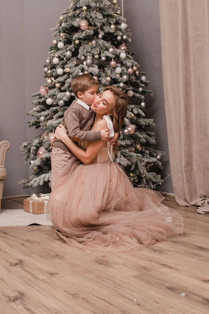 Mom and son near the Christmas tree New year concept