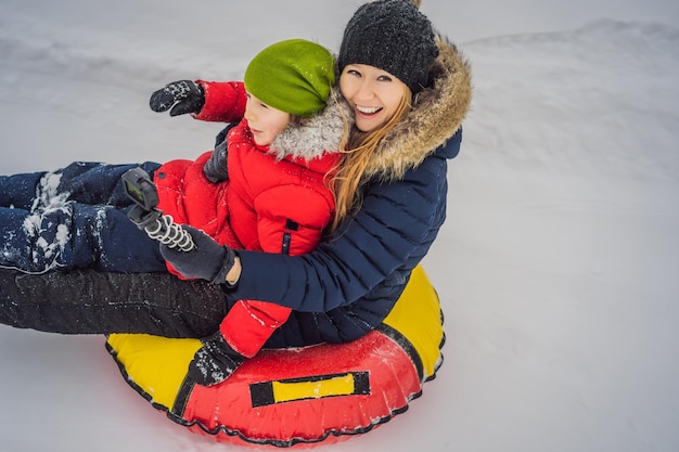 Mom son ride on an inflatable winter sled tubing winter fun for the whole family