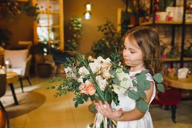 Mom and son with flowers in caffe. Son give flowers to mother. cute family. International women`s day, 8 march celebrating