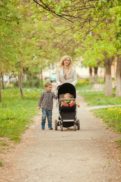 Mom walks with the child in a baby carriage