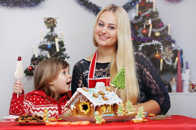 Mom with her daughter prepare ginger house