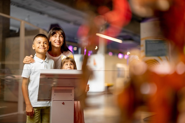 Mom with a kids interact with robot in science museum