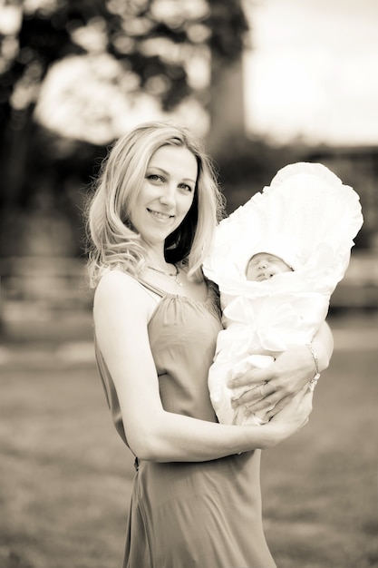 mom with a newborn baby outdoors