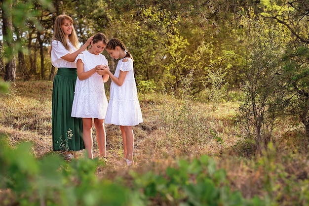 Mom with two daughters in the park.