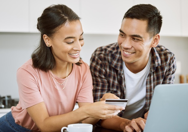 Money cant buy love because its overpriced Shot of a young couple buying items online at home