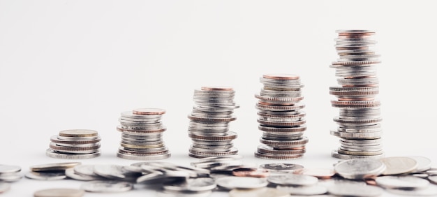 money coins arranged as a graph on white background