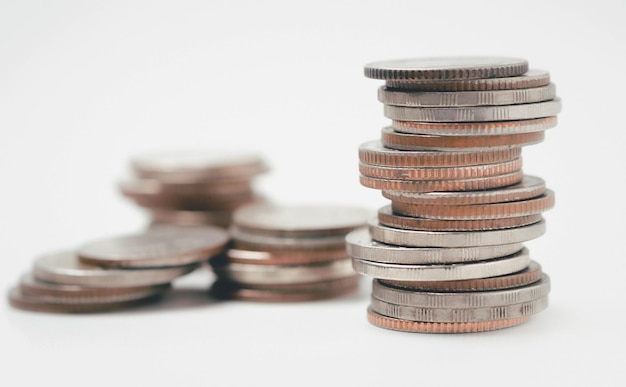 Money coins to stack of coinsSaving money for future use concept and money financial business growth concept isolated on white background