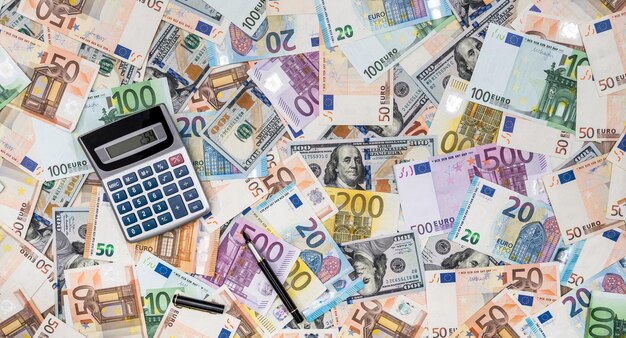 Money dollars and euro banknotes and calculator as finance background Exchange rate most main world currency