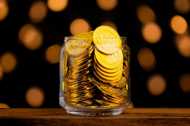 Money in a glass jar coin savings concept