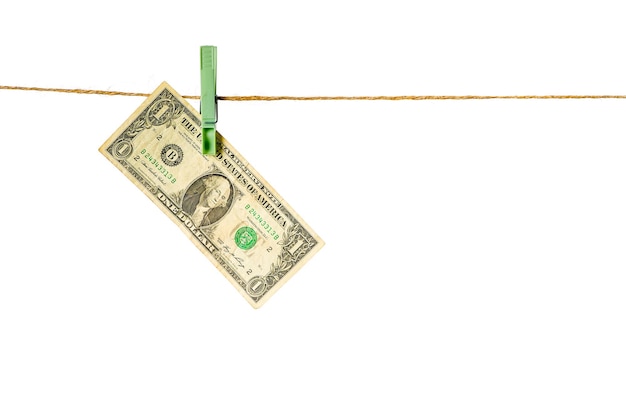 Money laundering Dollar banknotes hanging on clothesline isolated on white background