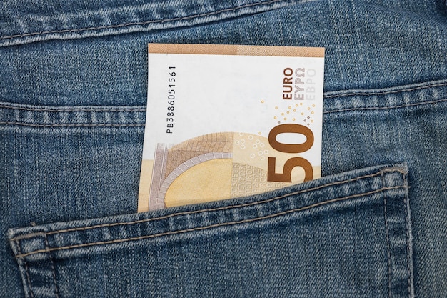 Money in the pocket Fifty euro note in the pocket of blue jeans