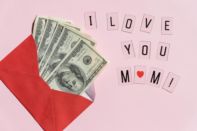 Money in red envelopes Happy mothers day greeting gift closed up of pile of US dollar banknotesBanknotes folded in an envelope as a present Sending or saving money corruption concept