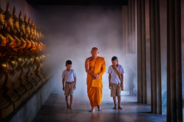 Monk and tow boy student at budha centre