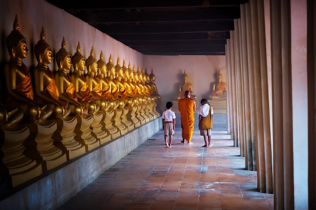 Monk and tow boy student at budha centre