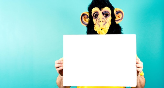 Monkey Masked Person Holding Blank Advertising Board