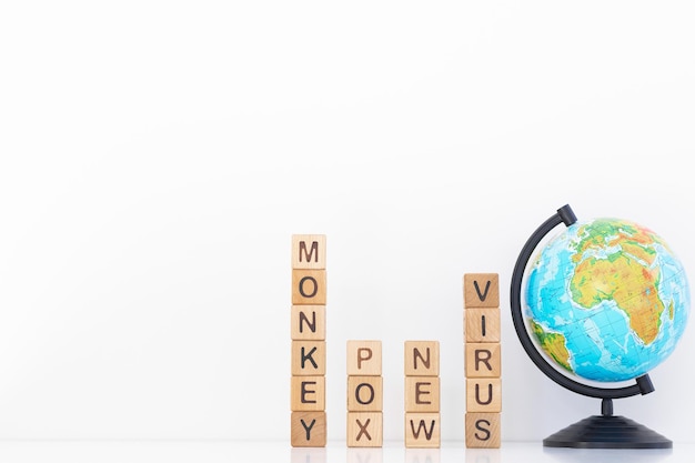 Monkey pox word is written on wooden cubes on a white background Closeup of wooden elements