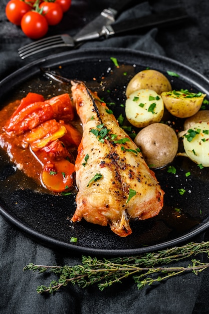 Monkfish baked in tomatoes with vegetables