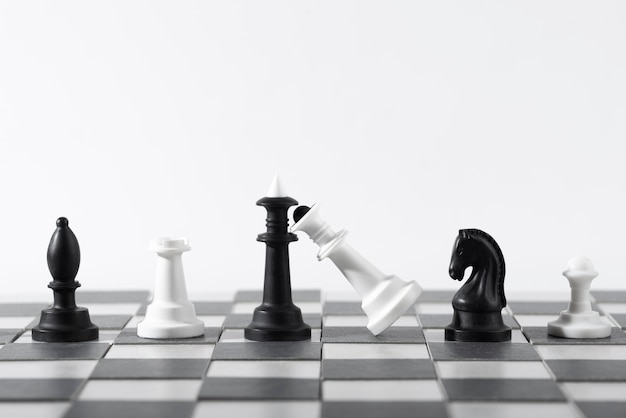 Monochrome chess pieces with game board