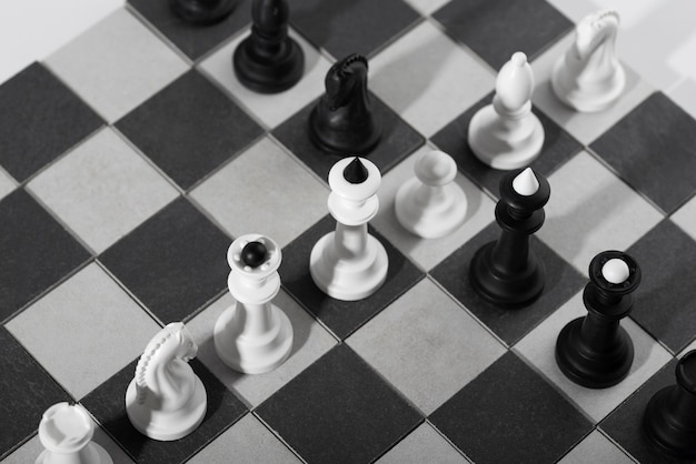 Monochrome chess pieces with game board