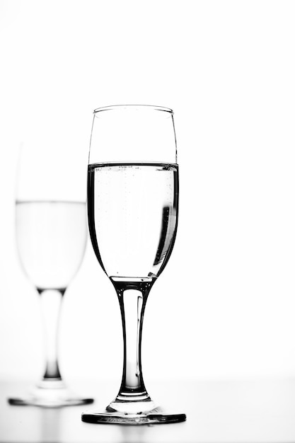 Monochrome photo of champagne on white table on white background isolate