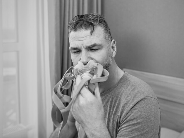 monochrome portrait of Happy rested man with chronic breathing issues after using CPAP machine