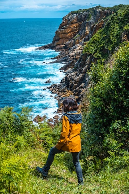 Monte Ulia in the city of San Sebastián, Basque Country. Visit the hidden cove of the city called Illurgita Senadia or Illurgita Senotia. A young woman arriving at the cove of mount ulia